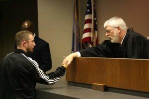 Judge MacKenzie congratulating a gradute